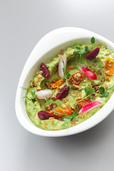 Organic plant based hummus with granola tomato, fresh thymes and rose leaf toppings. Perfect for vegan gluten free. Food photography.