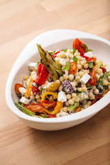 Healthy chick peas salad mixed with bell pepper cheese and dried tomatoes. Perfect for vegan. Freshly home made organic dish for take away and delivery.