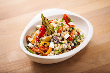 Healthy chick peas salad mixed with bell pepper cheese and dried tomatoes. Perfect for vegan. Freshly home made organic dish for take away and delivery.