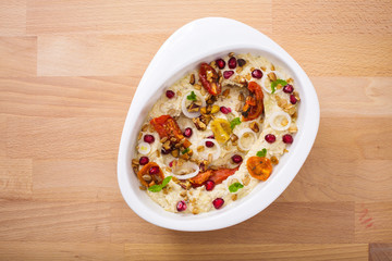 Organic plant based hummus with granola dried tomatoes toppings. Perfect for vegan gluten free. Freshly homemade for takeaway and delivery. Healthy food photography.