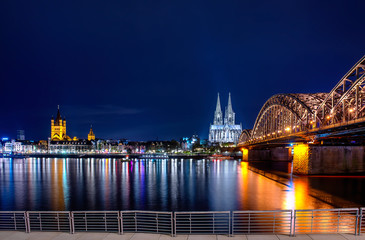 Panorama of the Hohenzollern Bridge over the Rhine River and Cologne Cathedral by night, Cologne...