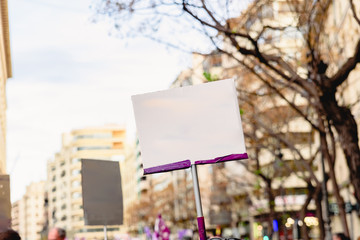 Blank banners held by people during demonstrations, to be completed with text.
