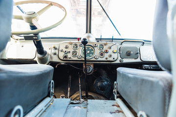 Dashboard and steering wheel of an old retro American van still in use.
