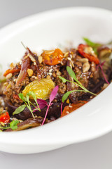 Delicious healthy salad with eggplant and dried tomatoes toppings. For healthy living. Perfect for takeaway and delivery. Vegan food photography focus view.