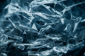 Blue monochrome abstract polythene wrap package. Abstract reflections on the plastic surface. lines, shadows with empty space for text for background