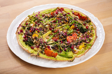 Delicious fresh homemade manakish with asparagus, dried tomatoes, quinoa and spring onions. Perfect for vegetarian. Healthy food photography concept.