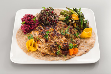 Grilled chicken yoghurt with salad side dish. beetroot, asparagus, and quinoa. Perfect for healthy living vegetarian. Organic food photography concept.