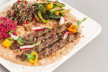 Delicious homemade kebab with salad side dish. beetroot, asparagus, and quinoa. Organic food photography focus view.