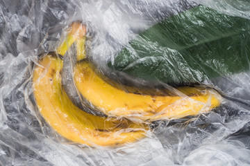 yellow ripe bananas with a plastic film polyethylene abstraction