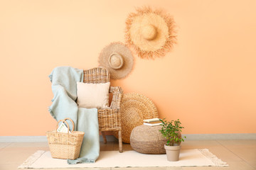 Fototapeta premium Comfortable armchair with decor near color wall in room
