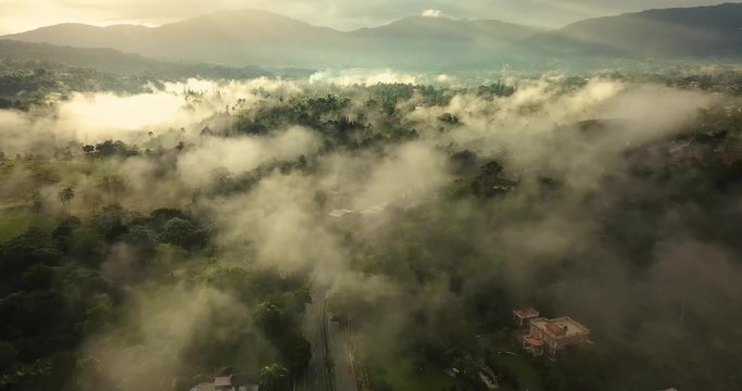 aerial footage  of a foggy landscape in early morning over jarabacoa dominican republic
