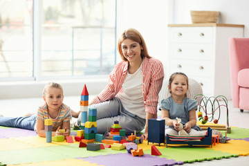 Mother playing with her children at home