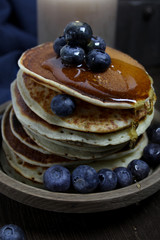 national dish pancakes, pancakes, pita with blueberries, linen napkin, poured with honey, concept of traditional cuisine