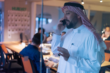 Middle Eastern businessman talking on the phone  in his office. Businessman Arabic using mobile phone for connection to communication.Business Technology concept.
