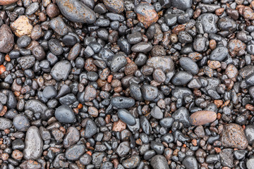 Black stones on the beach of Maui
