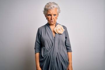 Senior beautiful grey-haired woman wearing casual dress standing over white background skeptic and nervous, frowning upset because of problem. Negative person.