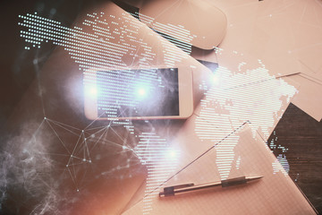 Double exposure of social network theme drawing over table with phone. Top view. People connecting concept.