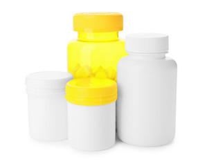 Bottles of different pills on white background