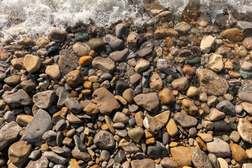 A wave crashing on a rocky beach