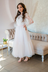 Girl model posing in a wedding dress.