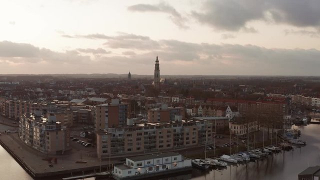 High angle shot of the historical city Middelburg, flying towards the big tower the Lange Jan. Drone shot.