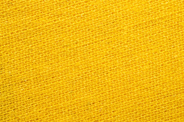 Yellow textile. knitted fabric texture. woven material close up