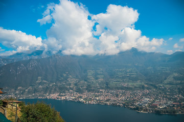 Obraz premium View from Monte Isola Island and mountain in Lombardy, Northern Italy on the small towns of Sulzano and Sale Marasino. View from a high point of the hike to Madonna della Ceriola Church