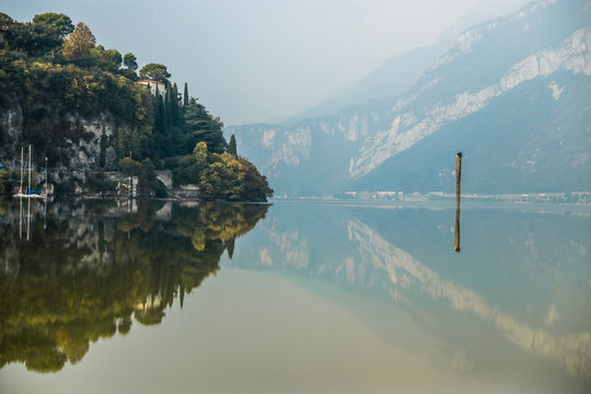 Beautiful reflection in the water of Lake Como, near the town of Lecco in Lombardy, Northern Italy. Landscape, scenic picture.