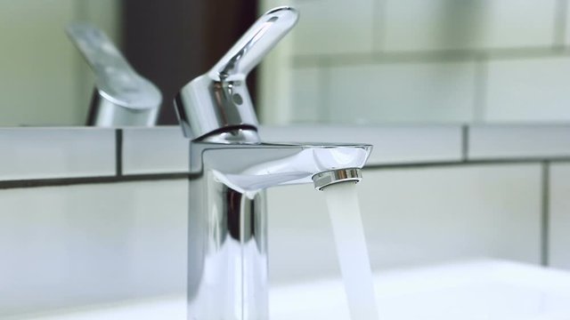 The hand opens and closes the water tap