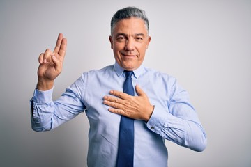 Middle age handsome grey-haired business man wearing elegant shirt and tie smiling swearing with hand on chest and fingers up, making a loyalty promise oath