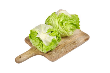 Iceberg lettuce on wooden cutting board, leafy green vegetable isolated on white background