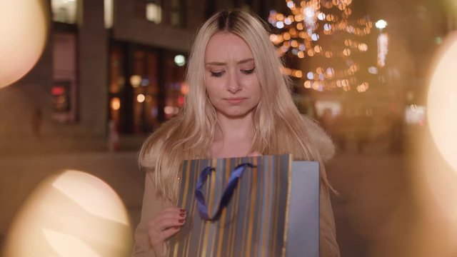 attractive young lady is dissapointed at the present she recieves
