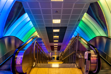 Subway station escalators with colorful walls