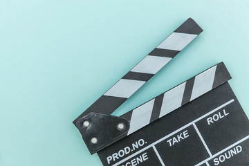 Fototapeta na wymiar Filmmaker profession. Classic director empty film making clapperboard or movie slate isolated on blue background. Video production film cinema industry concept. Flat lay top view copy space mock up.
