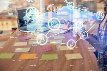 Double exposure of woman hands typing on computer and social network theme hologram drawing. People media concept.