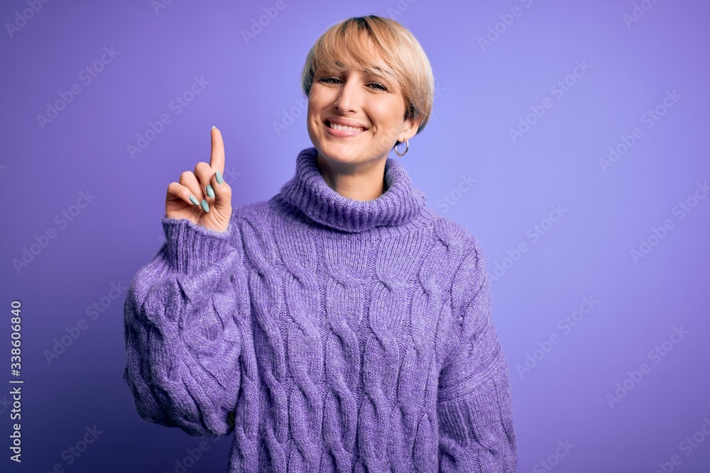 Sticker young blonde woman with short hair wearing winter turtleneck sweater over purple background showing 