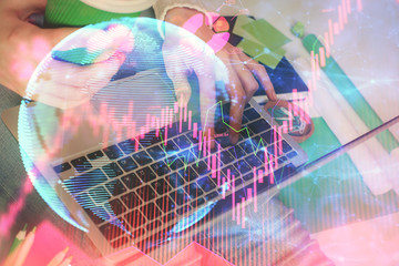 Double exposure of woman hands typing on computer and business theme hologram drawing. Success concept.