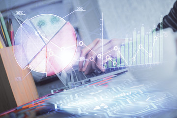 Double exposure of woman hands typing on computer and forex chart hologram drawing. Stock market invest concept.
