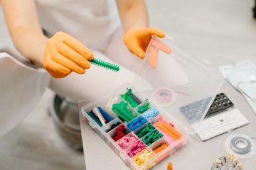 Detail of hand holding dental tools in dental clinic. Dentist Concept.