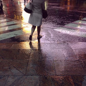 Low Section Of Woman Walking On Road