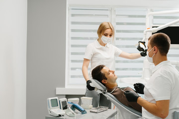 Doctor Dentist with an assistant work in a dental clinic.