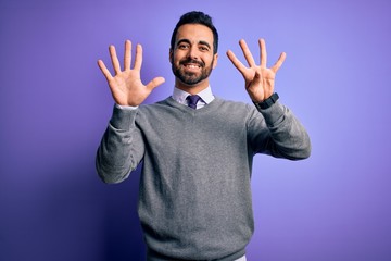 Fototapeta premium Handsome businessman with beard wearing casual tie standing over purple background showing and pointing up with fingers number nine while smiling confident and happy.