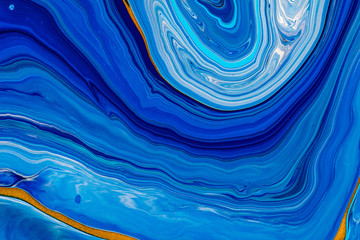 Fluid art texture. Abstract backdrop with swirling paint effect. Liquid acrylic artwork with flows and splashes. Classic blue color of the year 2020. Blue, golden and white overflowing colors © Mirror Flow