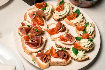 assorted sandwiches with different fillings of meat, vegetables, cheeses and so on. Horizontal frame