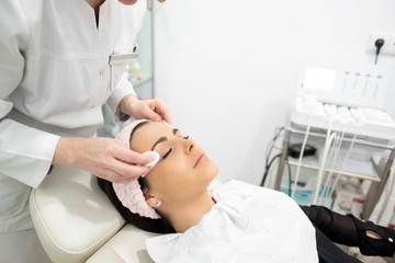 A girl getting facial and beauty care in a beauty clinic