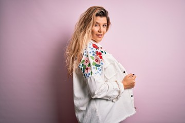 Young beautiful woman wearing fashion urban clothes, model wearing casual street style standing over pink background