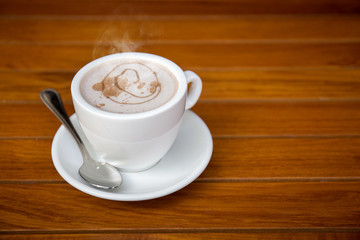 Cup of coffee on wooden table
