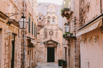 Old town street in Dubrovnik with view on church
