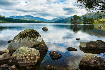 Fototapeta na wymiar Rocks along shore of lake in Scottish Highlands