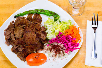 Gyro kebab with salad and rice on plate 